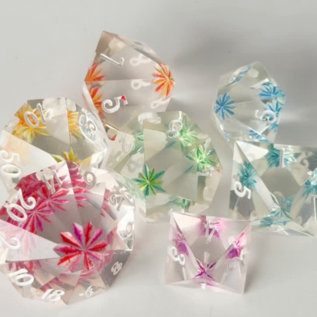 Set of colorful transparent dice with floral designs on a white background