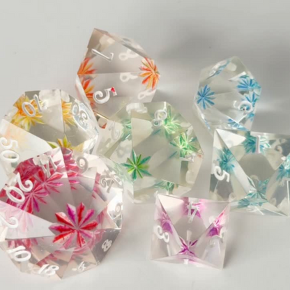 Set of colorful transparent dice with floral designs on a white background