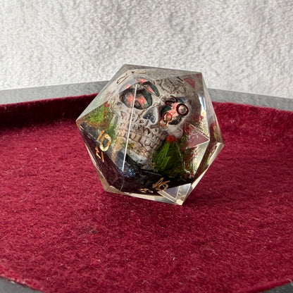 Crystal dice with skull design on a red surface